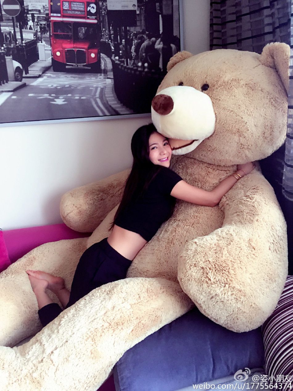近日，中国跳水队美女何姿在微博中秀了一组和超大玩具熊的照片，卖萌要抱抱。