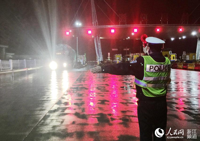 12月24日，是西方的平安夜，杭徽高速公路昱岭关收费站作为浙皖两省的省际站，担负着保障车辆平安畅通的重要工作。昱岭关收费站的气温较城市约低5℃左右，晚上还下起了淅淅沥沥的小雨。当天晚上10点，浙江省公安厅高速公路杭州交警支队一大队民警刘延东正在执勤。穿着反光服、举着LED停牌，不停对车辆进行&ldquo;收放&rdquo;。王婕 摄