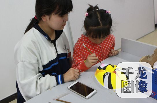 市民小朋友学习绘制脸谱。千龙网记者崔艳爽摄