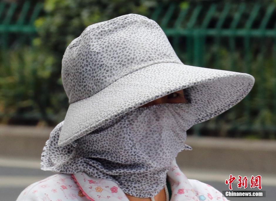 浙江高温已持续7天 市民“全副武装”出行
