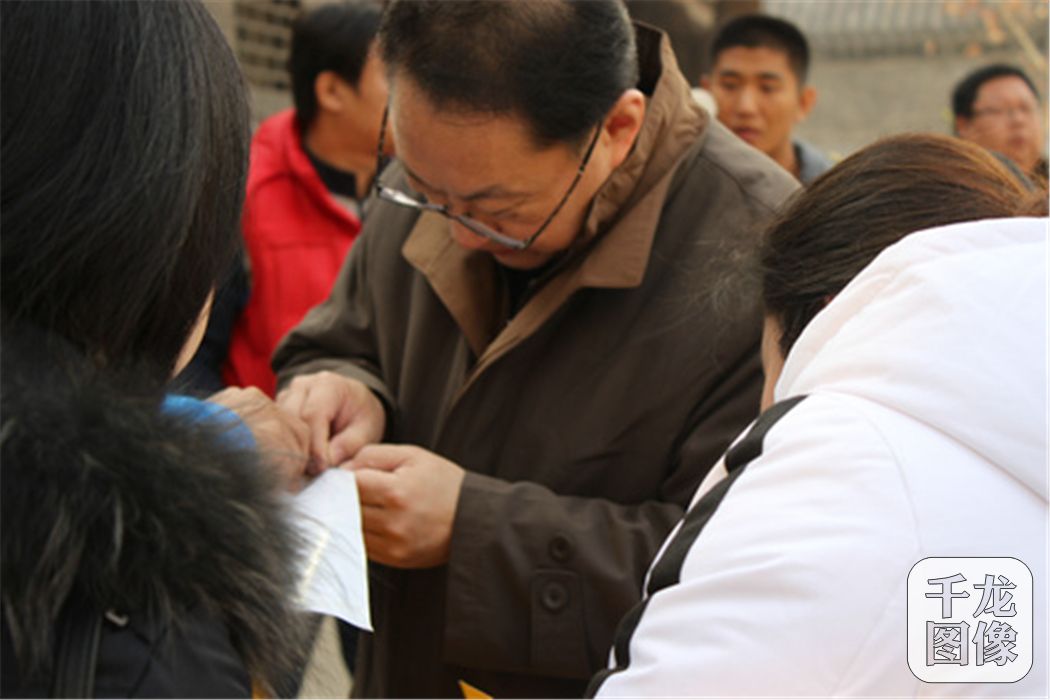 市金融局副巡视员沈鸿和其他人员一起撕开海报