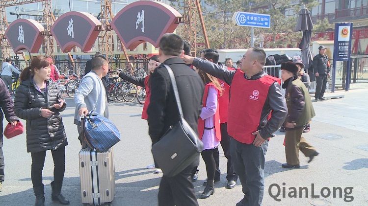 义工们帮着外地来京旅游的人指引着道路。