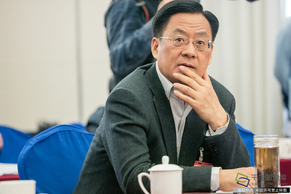 图为委员对千龙网全景相机产生浓厚兴趣，仔细端详全景相机