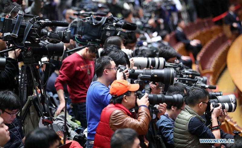 Journalists work during the opening meeting of the fifth session of China's 12th National People's Congress (NPC) at the Great Hall of the People in Beijing, capital of China, March 5, 2017. (Xinhua/Xie Huanchi)