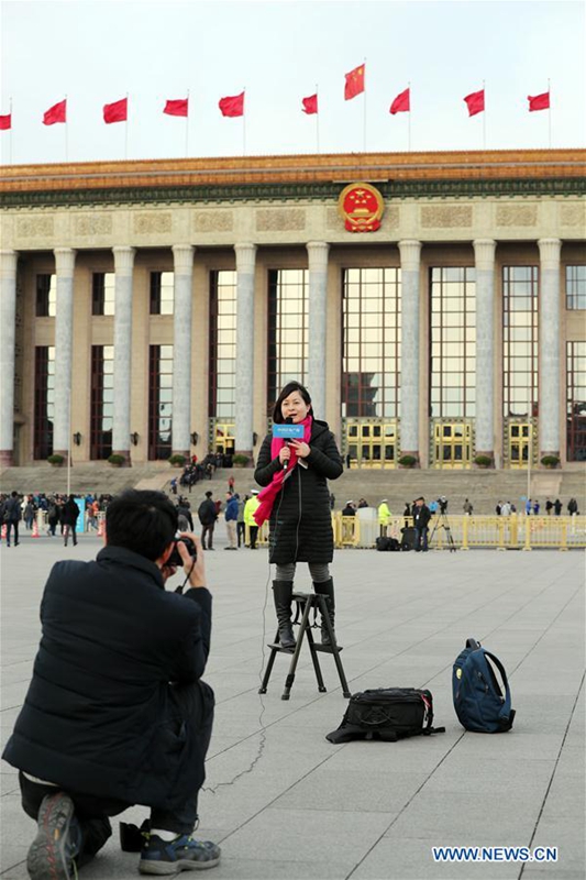 A female journalist works at the Tian'anmen Square in Beijing, capital of China, March 5, 2017. The International Women's Day falls on March 8, during the ongoing sessions of China's National People's Congress (NPC) and the Chinese People's Political Consultative Conference (CPPCC). (Xinhua/Yao Dawei)