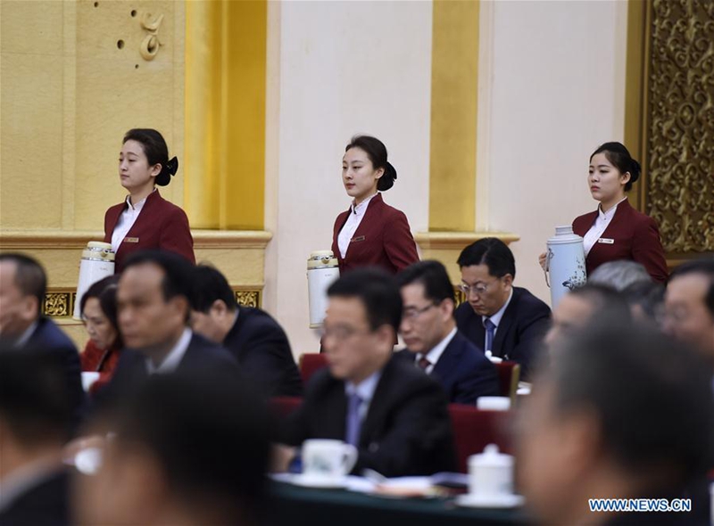 Female attendants work at a plenary meeting of the 12th National People's Congress (NPC) deputies from Guangdong Province during the annual NPC session in Beijing, capital of China, March 7, 2017. The International Women's Day falls on March 8, during the ongoing sessions of China's NPC and the Chinese People's Political Consultative Conference (CPPCC). (Xinhua/Yan Yan)