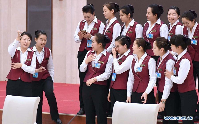 Female attendants gather after a day's work at a hotel accommodated by members of the 12th National Committee of the Chinese People's Political Consultative Conference (CPPCC) in Beijing, capital of China, March 6, 2017. The International Women's Day falls on March 8, during the ongoing sessions of China's National People's Congress (NPC) and the CPPCC. (Xinhua/Zhang Duo) 