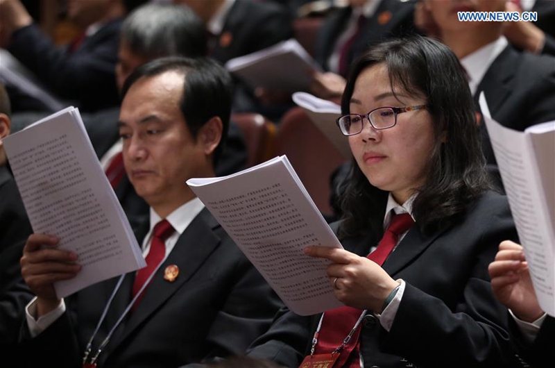 Staff members of the Supreme People's Court attend the third plenary meeting of the fifth session of the 12th National People's Congress at the Great Hall of the People in Beijing, capital of China, March 12, 2017. (Xinhua/Jin Liwang)