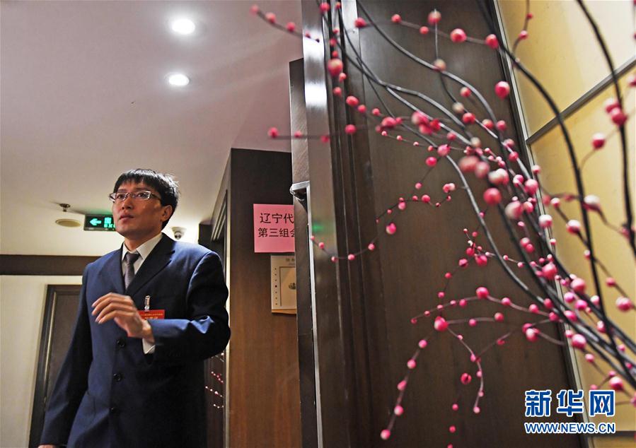 这是3月10日，王尚典走出十二届全国人大五次会议辽宁代表团小组会议会场。 新华社记者 杨青 摄