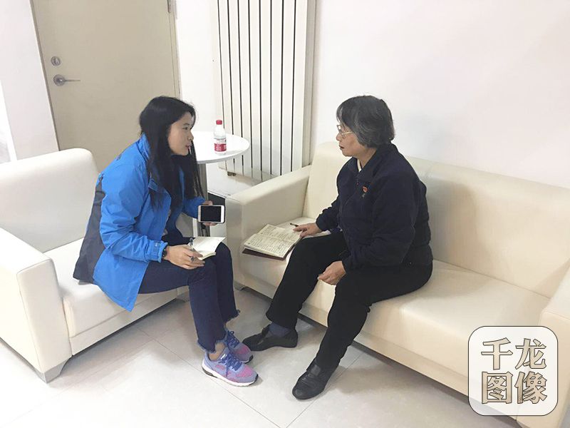 10月18日上午，密云区向阳西社区党群活动服务中心40多名社区居民和社区工作者齐聚一堂观看党的十九大开幕式。图为千龙网记者采访老党员赵连华。向阳西社区供图 千龙网发 