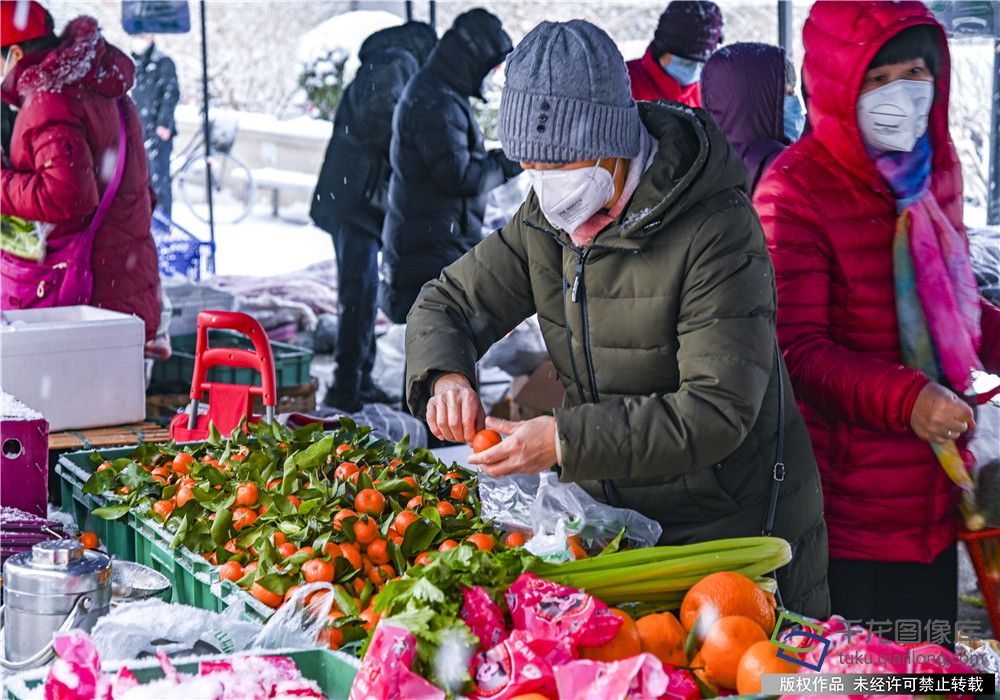 蔬菜直通车冒雪按时为社区居民送来新鲜蔬菜和水果。王保生摄 千龙网发