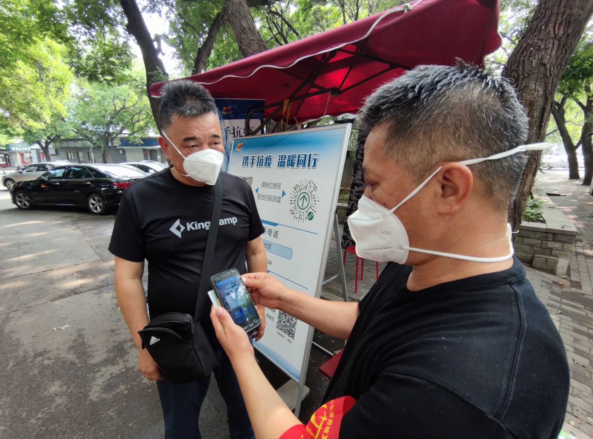 “您好，请出示身份证……”在北新华街社区双栅栏胡同卡口，一名志愿者拿出手持核验移动终端，对准备进入的居民说道。记者看到，志愿者通过手持核验移动终端扫描居民身份证后，设备屏幕上显示出居民姓名、核酸检测及疫苗接种等信息。查验信息合格后，居民可立即通行。