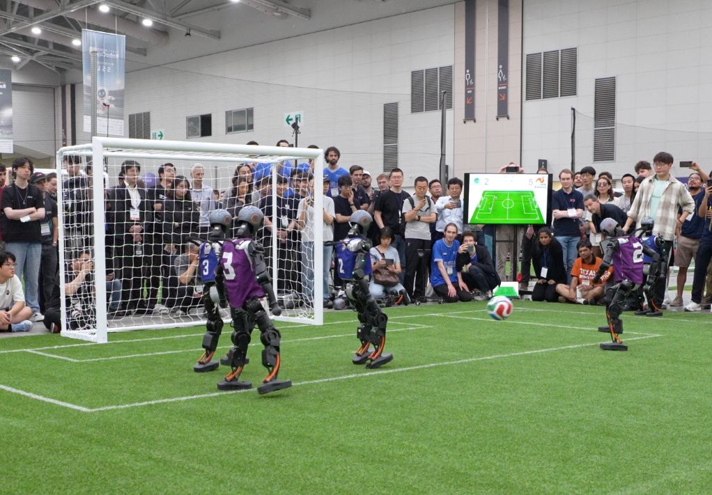 Tsinghua Huoshen robot shooting during the match. Xinhua